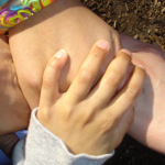 Desiree, Vanessa, Shana and Grace clasp hands.